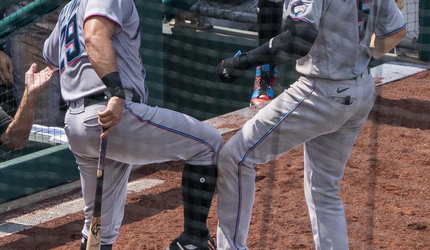 Miami Marlins' Brian Anderson, right, celebrates his two-run home run with Francisco Cervelli, left, during the fifth inning of a baseball game against the Philadelphia Phillies, Sunday, July 26, 2020, in Philadelphia. (AP Photo/Chris Szagola)