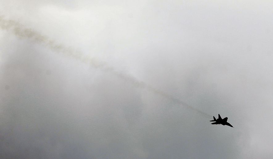 FILE - In this Tuesday, May 9, 2017 file photo, a Serbian army MiG-29 jet fighter performs during exercise at a ceremony marking 72 years since the end of WWII and the defeat of Nazi Germany, at Nikinci training ground, 60 kilometers west of Belgrade, Serbia. Serbia will continue to strengthen its armed forces and is ready to purchase more warplanes amid simmering tensions in the Balkans, the Serbian president said Sunday, July 26, 2020. (AP Photo/Darko Vojinovic, file)