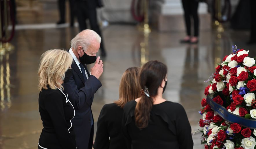 Democratic presidential candidate, former Vice President Joe Biden, and Jill Biden, pay their respects to Rep. John Lewis, D-Ga, as he lies in state at the Capitol in Washington, Monday, July 27, 2020. (Matt McClain/The Washington Post via AP, Pool)