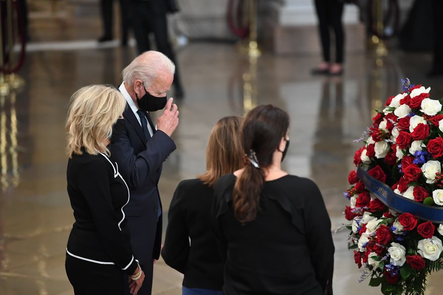 Democratic presidential candidate, former Vice President Joe Biden, and Jill Biden, pay their respects to Rep. John Lewis, D-Ga, as he lies in state at the Capitol in Washington, Monday, July 27, 2020. (Matt McClain/The Washington Post via AP, Pool)