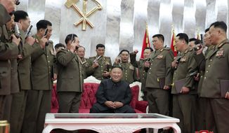In this Sunday, July 26, 2020, photo released by the North Korean government, North Korean leader Kim Jong Un, sitting center,  is surrounded by senior military officials holding “Paektusan” commemorative pistols they received from Kim during a ceremony in Pyongyang, North Korea. Independent journalists were not given access to cover the event depicted in this image distributed by the North Korean government. The content of this image is as provided and cannot be independently verified. Korean language watermark on image as provided by source reads: &amp;quot;KCNA&amp;quot; which is the abbreviation for Korean Central News Agency. (Korean Central News Agency/Korea News Service via AP)