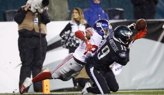 FILE - New York Giants&#39; Deandre Baker, left, breaks up a pass intended for Philadelphia Eagles&#39; J.J. Arcega-Whiteside during the second half of an NFL football game,in a  Monday, Dec. 9, 2019 file photo, in Philadelphia. New York Giants cornerback DeAndre Baker, Seattle Seahawks cornerback Quinton Dunbar and Washington receiver Cody Latimer have been put on the NFL&#39;s Commissioner Exempt List while facing felony charges from offseason incidents. (AP Photo/Matt Rourke, File)