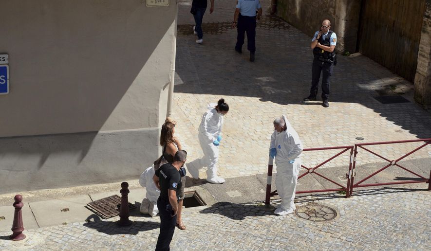 French police stand next a storm drain where the body of Laure Bardina-Kruger was found, in Peyriac de Mer, southern France, Friday, July 24, 2020. A French-American man from Brooklyn was in custody Sunday after he told police that he twice stabbed his wife whose body was found in a storm drain, a local newspaper reported. La Dépêche du Midi named the man as Billy Kruger and said he was detained Friday as he was preparing to fly from Toulouse. (AP Photo/Christophe Barreau)