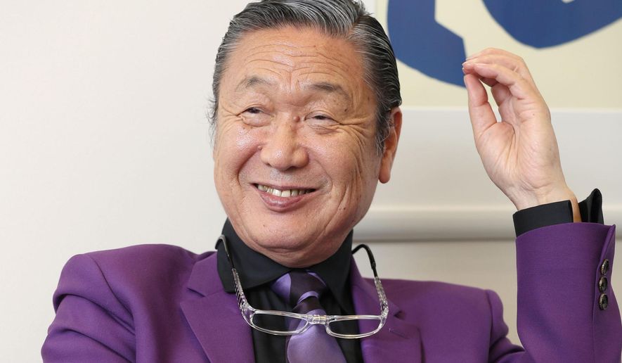 Japanese fashion designer Kansai Yamamoto speaks during an interview in Tokyo, in May, 2017. Yamamoto, known for his avant-garde and colorful work that included flamboyant costumes of the late rock icon David Bowie has died of leukemia, his company said on Monday, July 27, 2020. He was 76.(Kyodo News via AP)