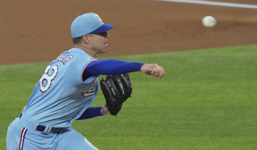 Texas Rangers starting pitcher Corey Kluber throws against the Colorado Rockies in the first inning of a baseball game Sunday, July 26, 2020, in Arlington, Texas. Kluber was removed from the game after one inning. (AP Photo/Louis DeLuca)