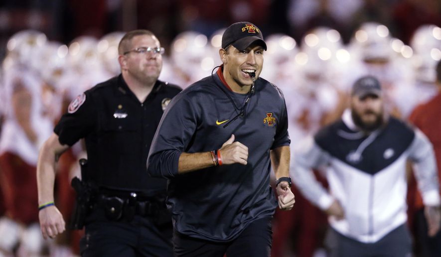 FILE - In this Nov. 9, 2019, file photo, Iowa State head coach Matt Campbell, center, runs off the field following warm-ups before an NCAA college football game between Iowa State and Oklahoma in Norman, Okla. Iowa State has added Ball State to its 2020 home football schedule to replace the canceled Cy-Hawk Series game against Iowa. The Cyclones and Cardinals will play Sept. 12. Ball State was available because its game at Michigan was canceled as part of the Big Ten's decision to play conference games only. (AP Photo/Sue Ogrocki, File)
