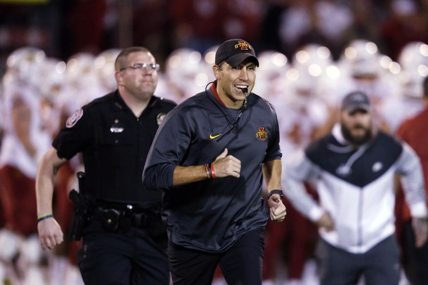 FILE - In this Nov. 9, 2019, file photo, Iowa State head coach Matt Campbell, center, runs off the field following warm-ups before an NCAA college football game between Iowa State and Oklahoma in Norman, Okla. Iowa State has added Ball State to its 2020 home football schedule to replace the canceled Cy-Hawk Series game against Iowa. The Cyclones and Cardinals will play Sept. 12. Ball State was available because its game at Michigan was canceled as part of the Big Ten's decision to play conference games only. (AP Photo/Sue Ogrocki, File)