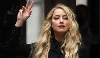 US Actress Amber Heard, former wife of actor Johnny Depp, arrives at the High Court in London, Tuesday, July 28, 2020. Hollywood actor Johnny Depp is suing News Group Newspapers over a story about his former wife Amber Heard, published in The Sun in 2018 which branded him a &#39;wife beater&#39;, a claim he denies. (AP Photo/Frank Augstein)