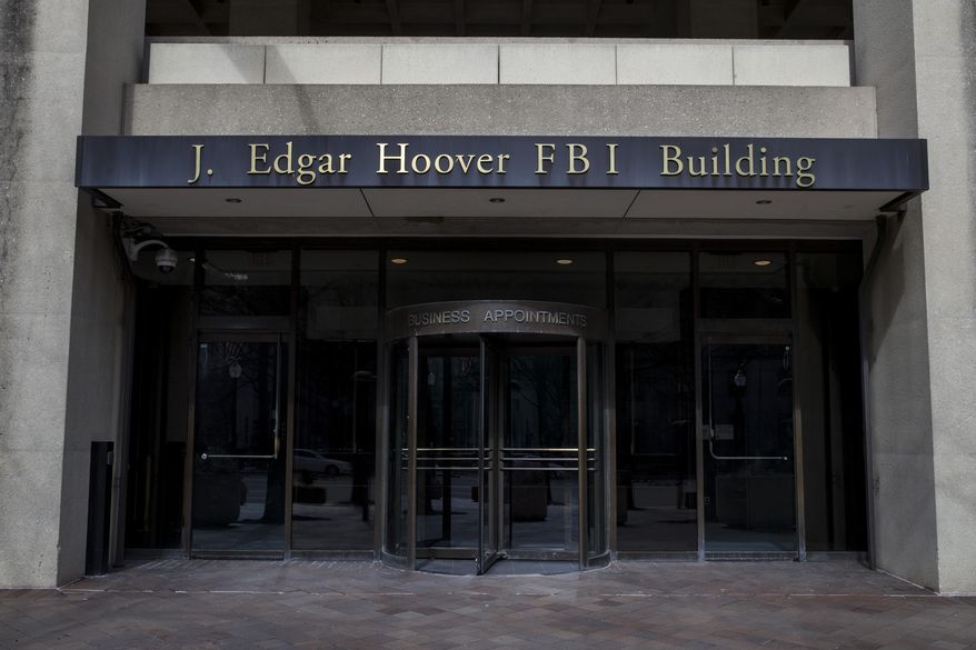 In this March 4, 2019, file photo, the J. Edgar Hoover FBI Building is seen in Washington. (AP Photo/Alex Brandon, File)