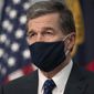 Governor Roy Cooper wears a face covering as he closes his press briefing on the COVID-19 virus at the Emergency Operations Center on Tuesday, July 28, 2020, in Raleigh, N.C. (Robert Willett/The News &amp;amp; Observer via AP)