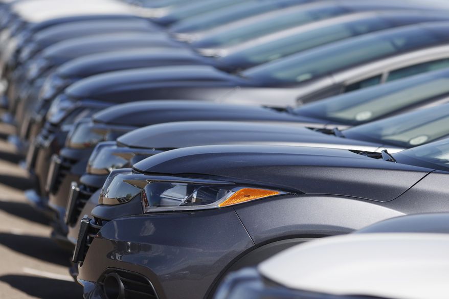 FILE - In this file photo dated June 7, 2020, a long row of unsold cars at a Honda dealership in Highlands Ranch, Colo. The coronavirus pandemic is causing drivers to keep their cars and trucks longer. The IHS Markit consulting firm says the pandemic has caused consumers to put the brakes on spending and hold onto their current vehicles for a longer period. (AP Photo/David Zalubowski, File)