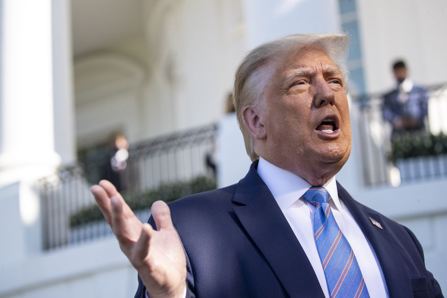 President Donald Trump speaks with reporters as he walks to Marine One on the South Lawn of the White House, Wednesday, July 29, 2020, in Washington. Trump is en route to Texas. (AP Photo/Alex Brandon)