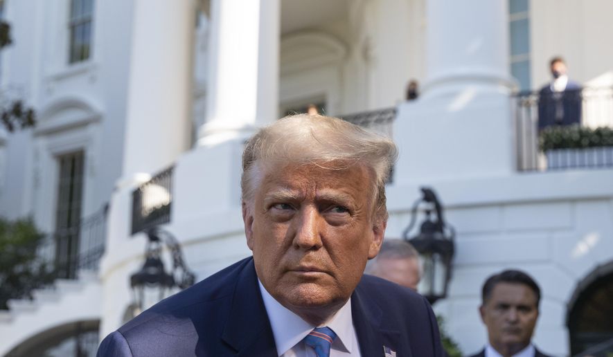 President Donald Trump leans in to hear a question as he speaks with reporters before walking to Marine One on the South Lawn of the White House, Wednesday, July 29, 2020, in Washington. Trump is en route to Texas. (AP Photo/Alex Brandon)