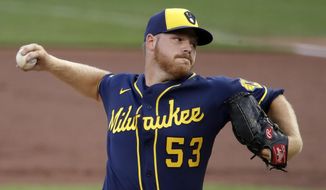 Milwaukee Brewers starting pitcher Brandon Woodruff delivers during the first inning of a baseball game against the Pittsburgh Pirates in Pittsburgh, Wednesday, July 29, 2020. (AP Photo/Gene J. Puskar)