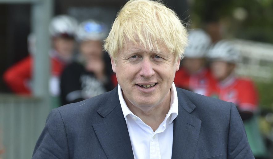 FILE - In this Tuesday, July 28, 2020 file photo, Britain's Prime Minister Boris Johnson speaks to local people at the Canal Side Heritage Centre in Beeston near Nottingham, England. Johnson is looking for a spokesperson with broadcasting experience— and a thick skin — to become the government’s face at televised media briefings. The government placed a job ad Wednesday, July 29 on the governing Conservative Party’s website seeking applicants with news judgment, the ability to remain calm under pressure and “excellent risk management and crisis communications skills.” (AP Photo/Rui Vieira, file)