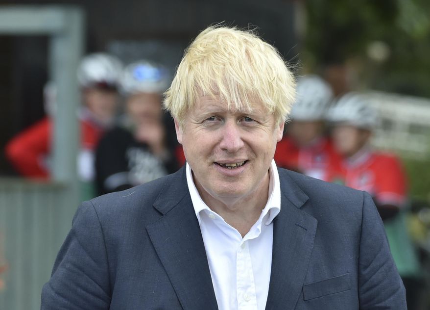 FILE - In this Tuesday, July 28, 2020 file photo, Britain's Prime Minister Boris Johnson speaks to local people at the Canal Side Heritage Centre in Beeston near Nottingham, England. Johnson is looking for a spokesperson with broadcasting experience— and a thick skin — to become the government’s face at televised media briefings. The government placed a job ad Wednesday, July 29 on the governing Conservative Party’s website seeking applicants with news judgment, the ability to remain calm under pressure and “excellent risk management and crisis communications skills.” (AP Photo/Rui Vieira, file)