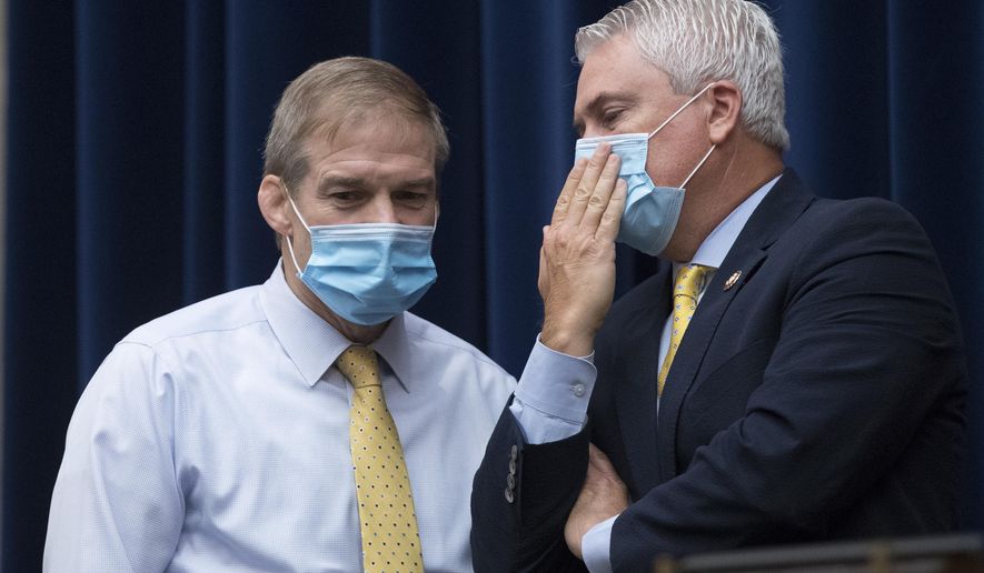 Ranking Member Rep. James Comer, R-Ky., right, speaks with Rep. Jim Jordan, R-Ohio, left, during a House Committee on Oversight and Reform hearing on the 2020 Census​ on Capitol Hill, Wednesday, July 29, 2020, in Washington. (AP Photo/Andrew Harnik)