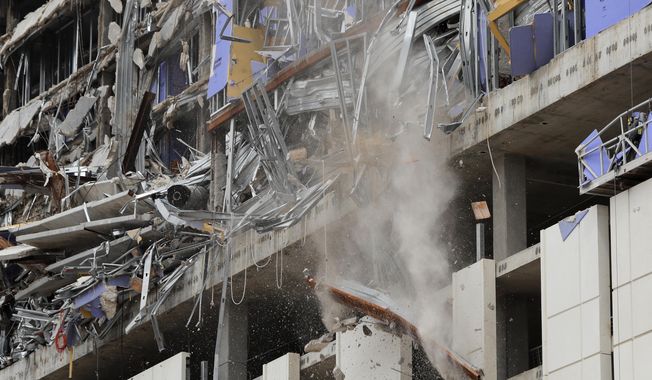 A wrecking ball knocks debris loose from the Hard Rock Hotel building collapse site in New Orleans, Monday, July 20, 2020. New Orleans&#x27; fire chief says it&#x27;s taking longer than expected to remove the bodies of two construction workers from a hotel that partially collapsed during construction 10 months ago. Fire Superintendent Tim McConnell said that the first may be out by the end of this week and the other next week. (AP Photo/Gerald Herbert)