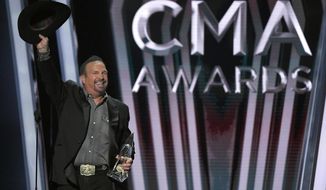 FILE - Garth Brooks accepts the award for entertainer of the year at the 53rd annual CMA Awards in Nashville, Tenn. on Nov. 13, 2019. Brooks says he is pulling himself out of nominations for the Country Music Association&#x27;s entertainer of the year award, saying it&#x27;s time for someone else to win the top prize. Brooks, who won the top prize last November, said during an online press conference on Wednesday that he doesn&#x27;t want to be nominated in any upcoming years as well.  (AP Photo/Mark J. Terrill, File)