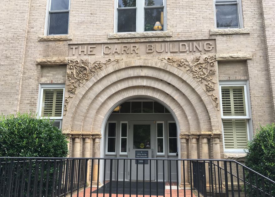 This Aug. 31, 2017 photo shows an entrance to the Carr Building on the campus of the University of North Carolina in Chapel Hill, N.C. The University of North Carolina-Chapel Hill Board of Trustees voted on Wednesday, July 29, 2020, to remove the names of Carr and three other men who have ties to white supremacy and racism from campus buildings. (AP Photo/Jonathan Drew)