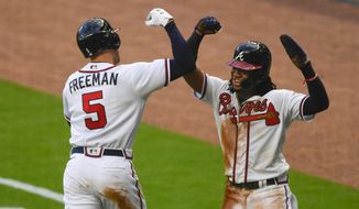 Atlanta Braves&#x27; Freddie Freeman (5) celebrates his two-run home run with Ronald Acuña during the third inning of a baseball game against the Tampa Bay Rays, Wednesday, July 29, 2020 in Atlanta. (AP Photo/John Amis)