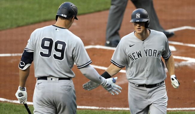 New York Yankees&#x27; Aaron Judge (99) greets DJ LeMahieu, right, after LaMahieu hit a solo home run off Baltimore Orioles starting pitcher Asher Wojciechowski during the first inning of a baseball game, Wednesday, July 29, 2020, in Baltimore. (AP Photo/Julio Cortez)