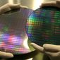 The dummies of a 200mm wafer, right, and a 300mm wafer, left, are seen at Advanced Micro Devices Inc. , in Dresden, Germany, Thursday, March 8, 2007. AMD snared a huge slice of the microprocessor market from archrival Intel Corp., only to find that it might have paid too high a price for its victories. (AP Photo/Matthias Rietschel)