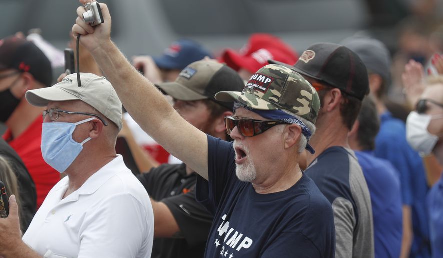 Supporters cheer and take pictures as Vice President Mike Pence speaks at a &quot;Cops for Trump&quot; campaign event at the police station, Thursday, July 30, 2020, in Greensburg, Pa. (AP Photo/Keith Srakocic)