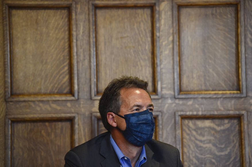Gov. Steve Bullock gives an update on the state's response to the Covid-19 during a press conference at the State Capitol in Helena, Mont., on Wednesday, July 29, 2020. (Thom Bridge/Independent Record via AP)