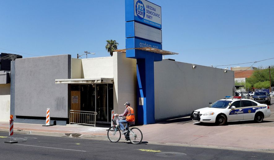 FILE - In this July 24, 2020, file photo, Phoenix Police block the entrance outside the Arizona Democratic Party headquarters following a fire in Phoenix. Authorities on Wednesday, July 29, 2020, announced an arrest in an arson fire that destroyed much of the Arizona and Maricopa County Democratic Party headquarters. Phoenix police said 29-year-old Matthew Egler was booked on one count of arson of an occupied structure. (AP Photo/Matt York, File)