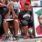 FILE - Trinetta Brown, center left, 19, and Triniya Brown become emotional during a memorial service for their brother, Michael Brown, Thursday, Aug. 9, 2018, in the Canfield Green apartment complex in Ferguson, Mo. St. Louis County&#x27;s top prosecutor announced Thursday, July 30, 2020, that he will not charge the former police officer who fatally shot Brown. But, he said, &amp;quot;our investigation does not exonerate Darren Wilson.&amp;quot; (Cristina M. Fletes/St. Louis Post-Dispatch via AP, File)