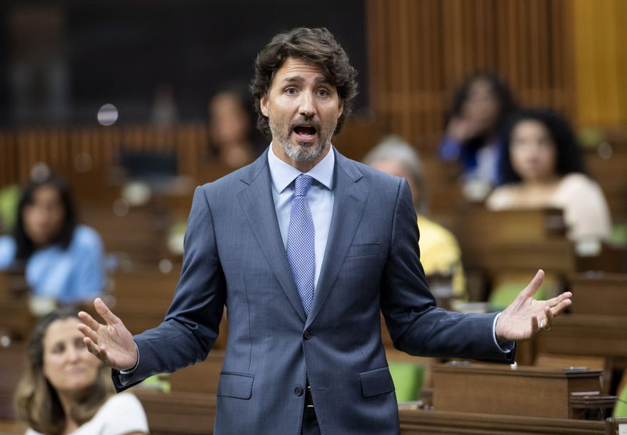Prime Minister Justin Trudeau rises during a sitting of the Special Committee on the COVID-19 Pandemic in the House of Commons Wednesday, July 22, 2020, in Ottawa. (Adrian Wyld/The Canadian Press via AP) ** FILE **