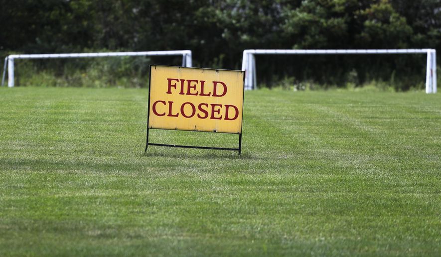 A sign announces that the field is closed at Vernon Hills Athletic Complex in Vernon Hills, Ill., Thursday, July 30, 2020. Governor J.B Pritzker introduced new restrictions for recreational sports leagues in Illinois Wednesday, as the number of coronavirus cases continues to rise across the state. (AP Photo/Nam Y. Huh)