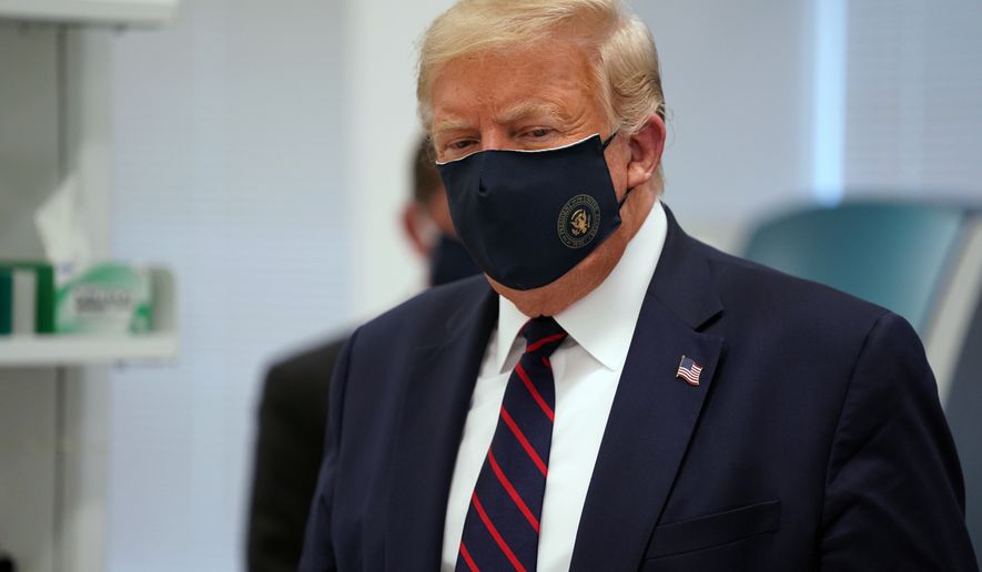 In this Monday, July 27, 2020, file photo, President Donald Trump wears a face mask as he participates in a tour at Fujifilm Diosynth Biotechnologies in Morrisville, N.C. (AP Photo/Evan Vucci) ** FILE **