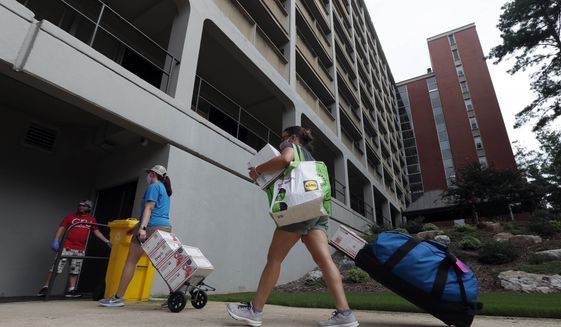 College students begin moving in for the fall semester at N.C. State University in Raleigh, N.C., Friday, July 31, 2020. (AP Photo/Gerry Broome)