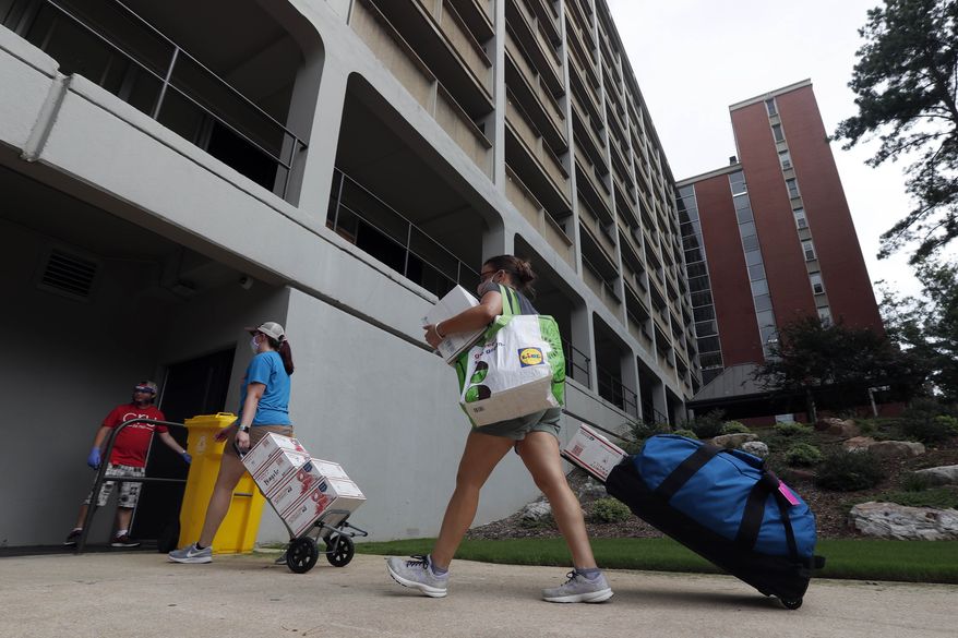 College students begin moving in for the fall semester at N.C. State University in Raleigh, N.C., Friday, July 31, 2020. (AP Photo/Gerry Broome)