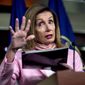 House Speaker Nancy Pelosi of Calif. uses a folder as a prop as she speaks about mail in voting during a news conference on Capitol Hill in Washington, Friday, July 31, 2020. (AP Photo/Andrew Harnik)