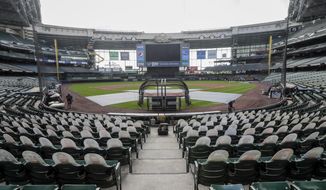 Fan cutouts are seen behind home plate at Miller Park after it was announced that the Milwaukee Brewers home opener was postponed after two St. Louis Cardinals employees tested positive for the coronavirus, Friday, July 31, 2020, in Milwaukee. (AP Photo/Morry Gash) ** FILE **