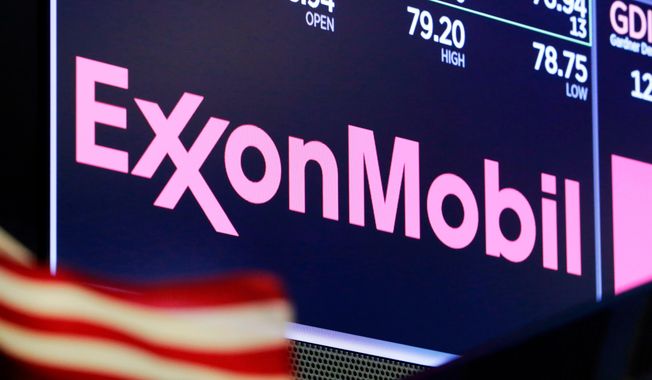In this April 23, 2018, file photo, the logo for ExxonMobil appears above a trading post on the floor of the New York Stock Exchange. Exxon lost $1.1 billion in the second quarter, Friday, July 31, 2020, its economic pain deepening as the pandemic kept households on lockdown, diminishing the need for oil around the world.  (AP Photo/Richard Drew, File)