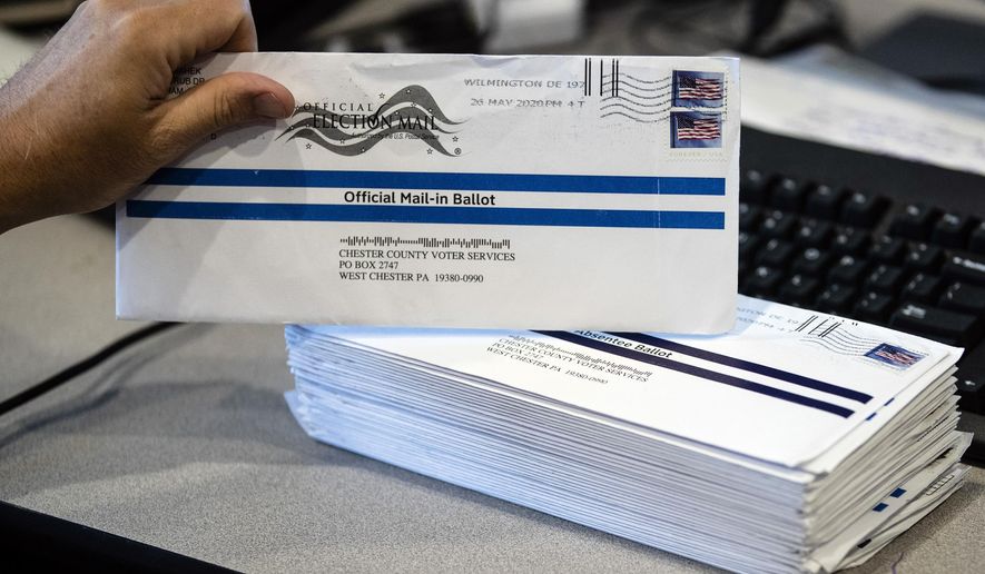 FILE - In this May 28, 2020, file photo, mail-in primary election ballots are processed at the Chester County Voter Services office in West Chester, Pa. Pennsylvania officials said Friday, July 31, 2020, the state will foot the cost of postage for voters to mail in ballots in November's general election, a move that Gov. Tom Wolf has made a priority as the coronavirus pandemic unexpectedly fueled high interest in voting by mail under a new state law. (AP Photo/Matt Rourke, File)