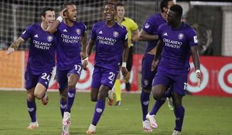 Orlando City forward Nani (17) celebrates after scoring the winning goal with teammates Kyle Smith (24), Andres Perea (21), Antonio Carlos (25) and Daryl Dike (18) after an MLS soccer match, against Los Angeles FC, Friday, July 31, 2020, in Orlando, Fla. (AP Photo/John Raoux)