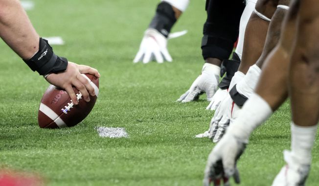In this Dec. 7, 2019, file photo, a player prepares to hike the ball at the line of scrimmage during the first half of the Big Ten championship NCAA college football game between Ohio State and Wisconsin in Indianapolis. Don Yee, one of sports&#x27; most influential agents, Tom Brady is one of his clients, has teamed with former ESPN and NFL Network executive  Jamie Hemann to develop HUB Football. The concept is simple, though the implementation could be very complex: It will provide opportunities for college players and street free agents to be seen in action by NFL teams. (AP Photo/AJ Mast, File)