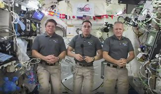 This photo provided by NASA shows from left, astronauts Bob Behnken, Chris Cassidy and Doug Hurley during an interview on the International Space Station on Friday, July 31, 2020. Behnken and Hurley are scheduled to leave the International Space Station in a SpaceX capsule on Saturday and splashdown off the coast of Florida on Sunday.  (NASA via AP)