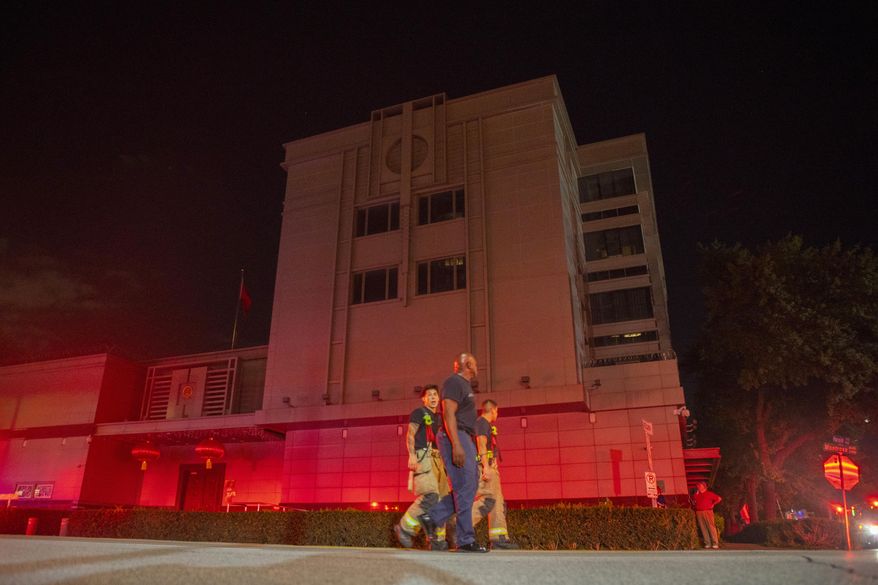 FILE - In this July 21, 2020, file photo the Houston Fire Department responds to reports of a fire inside the Chinese Consulate in Houston. In shutting each other’s consulates, the United States and China have done more than strike symbolic blows in their escalating feud. For China, the loss of its mission in Houston dims its view of America’s South and, according to U.S. officials, removes the nerve center of a Chinese spying network that spanned more than two dozen cities, collecting intelligence, trying to steal trade secrets and proprietary technology and research. (Mark Mulligan/Houston Chronicle via AP, File)