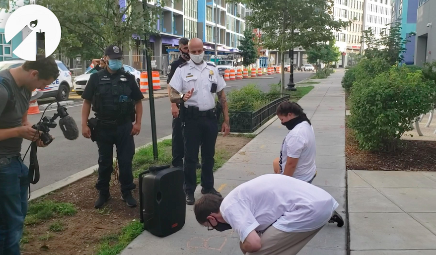 In this file photo, Metropolitan Police Department officers are shown in this video screen capture, just before they arrest two pro-life demonstrators with Students for Life of America in Northeast D.C. on August 1, 2020. The demonstrators were chalking the public sidewalk Saturday morning, an act an officer in the video said violated a law against defacing public property. On Nov. 18, 2020, Students for Life of America and the Frederick Douglass Foundation filed a lawsuit in federal court asking a judge to declare the city&#39;s defacement ordinance unconstitutional. (Video courtesy of Students for Life of America)  **FILE**
