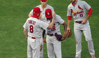 St. Louis Cardinals manager Mike Shildt (8) consoles pitcher Carlos Martinez on the cap as he pulls him following a solo home run by Minnesota Twins&#39; Josh Donaldson in the fourth inning of a baseball game Tuesday, July 28, 2020, in Minneapolis. (AP Photo/Jim Mone)