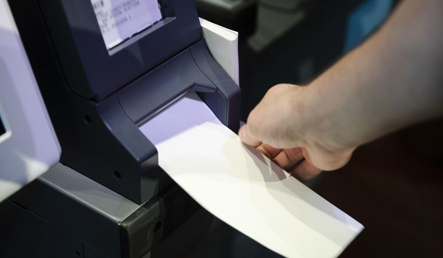 FILE—In this June 13, 2019 file photo, an Investigator with the Office of the City Commissioners, demonstrates the ExpressVote XL voting machine at the Reading Terminal Market in Philadelphia. As the Nov. 3 2020 presidential vote nears, there are fresh signs that the nation’s electoral system is again under attack from foreign adversaries.Intelligence officials confirmed in recent days that foreign actors are actively seeking to compromise the private communications of “U.S. political campaigns, candidates and other political targets” while working to compromise the nation's election infrastructure. (AP Photo/Matt Rourke, File)