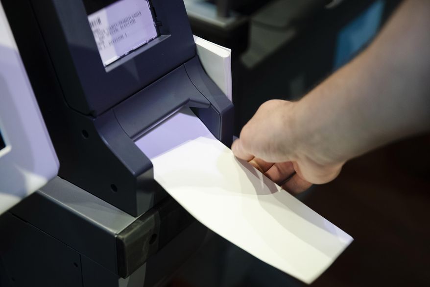 FILE—In this June 13, 2019 file photo, an Investigator with the Office of the City Commissioners, demonstrates the ExpressVote XL voting machine at the Reading Terminal Market in Philadelphia. As the Nov. 3 2020 presidential vote nears, there are fresh signs that the nation’s electoral system is again under attack from foreign adversaries.Intelligence officials confirmed in recent days that foreign actors are actively seeking to compromise the private communications of “U.S. political campaigns, candidates and other political targets” while working to compromise the nation's election infrastructure. (AP Photo/Matt Rourke, File)