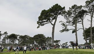 FILE - In this  Saturday, May 2, 2015 file photo, Rory McIlroy, left, of Northern Ireland, and Hideki Matsuyama, right, of Japan, make their way down the fairway after hitting from the eighth tee of TPC Harding Park at the Match Play Championship in San Francisco. Harding Park hosts the PGA Championship on Aug. 6-9, the first major without spectators.  (AP Photo/Eric Risberg, File)