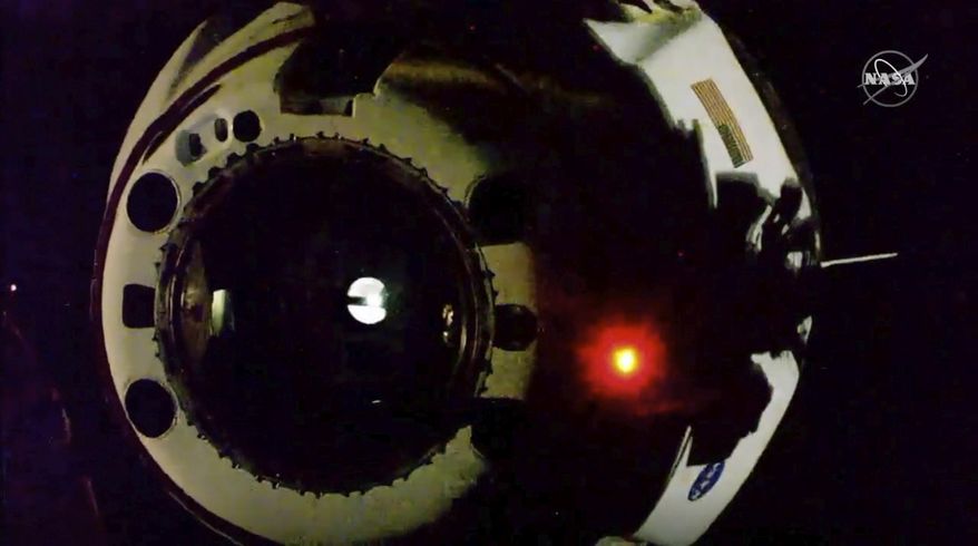 In this image from video made available by NASA, the SpaceX Crew Dragon capsule separates from the International Space Station on Saturday, Aug. 1, 2020. (NASA via AP)